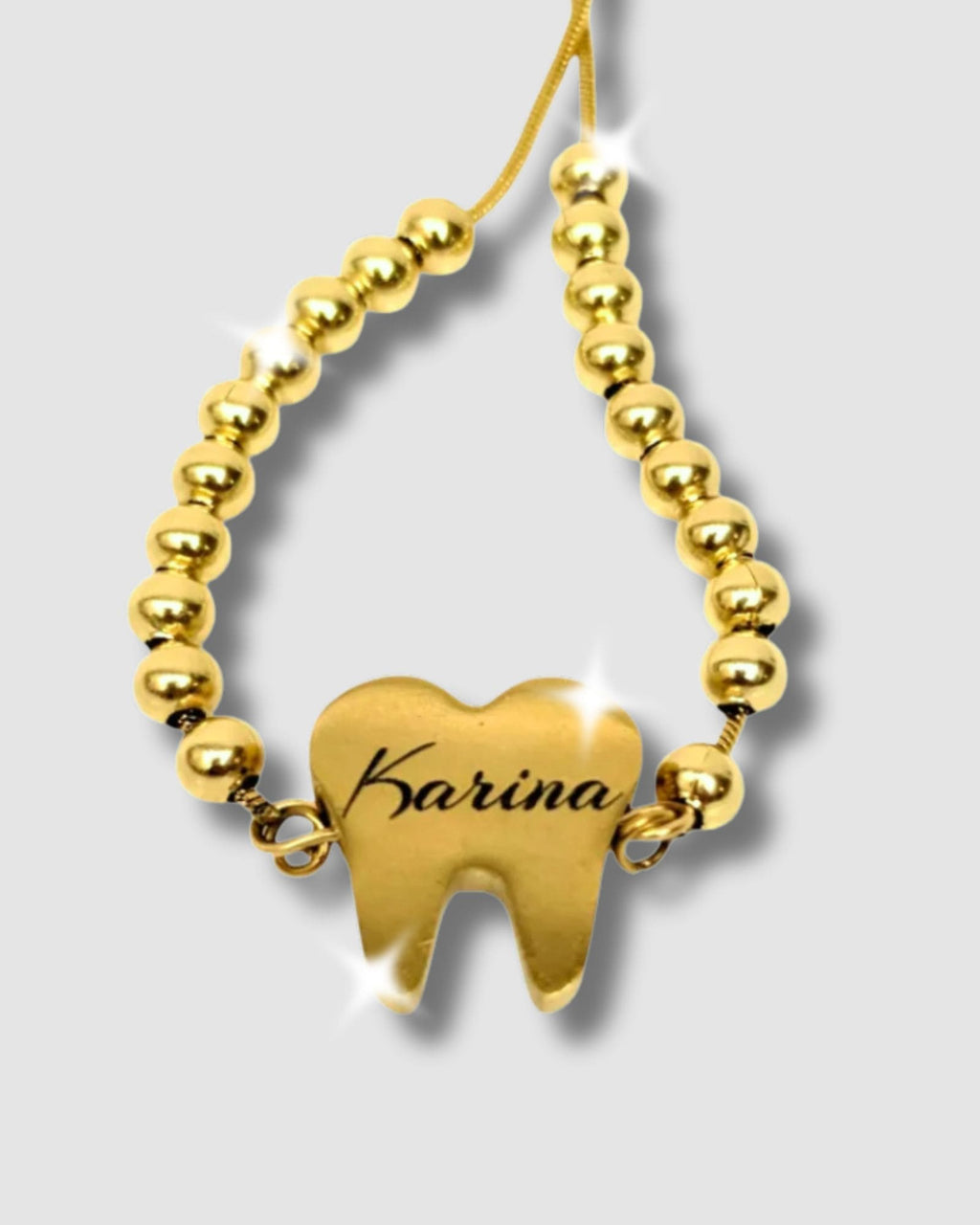 Pulsera en forma de diente con mensaje